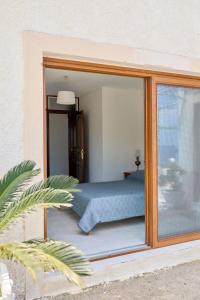 a bedroom with a bed through a glass window at 180 View Private 2 Bedroom Seaview Home in Samos