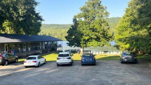 a group of cars parked in a parking lot at Motel Luzerne in Lake Luzerne