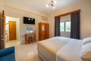 a bedroom with a bed and a window and a desk at Red Dragon Exclusive accommodation in Dassia