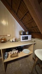 a kitchen with a stove and a microwave on a shelf at Ambra Apartaments Palanga in Palanga