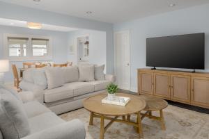 a living room with a couch and a flat screen tv at Elizabeth Pointe Lodge in Fernandina Beach