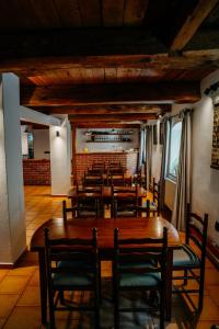 a dining room with wooden tables and chairs at Penzion Jiřičná in Jiřičná