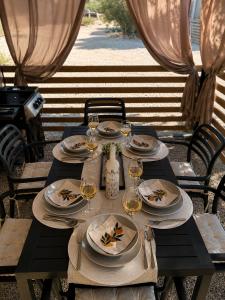 a wooden table with plates and glasses of wine at SevenSeasCove in Sukošan