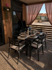 a dining room table with chairs and a television at SevenSeasCove in Sukošan