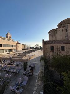 a patio with tables and chairs next to a building at SevenSeasCove in Sukošan +21 photos
