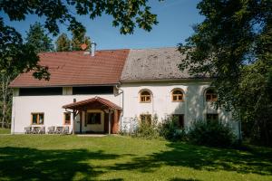 a large white house with a red roof at Penzion Jiřičná in Jiřičná