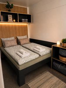 a bed with two pillows on it in a room at SevenSeasCove in Sukošan