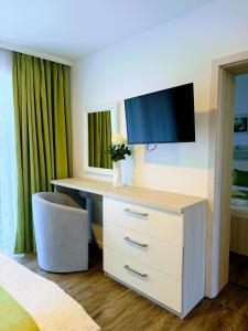 a bedroom with a desk with a tv on it at VILLA MEGER in Veľký Meder