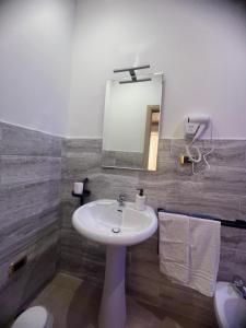 a bathroom with a sink and a mirror at Il Faro Suites in Taranto