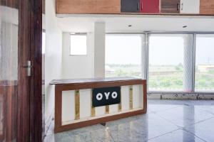 a sign that says oxy in a room with windows at Hotel O Highway Kitchen in Bara Khera