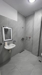 a bathroom with a sink and a mirror at Drymades Ruci Rooms in Dhërmi