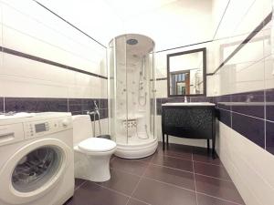 a bathroom with a washing machine and a toilet at D31 Hotel in Odesa +65 photos
