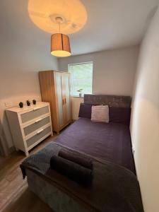 a small bedroom with a bed and a dresser at Stonebarn New in Halton
