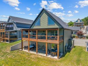 a house with a wrap around porch with a deck at Green Wood Getaway - for 18 in Hollister