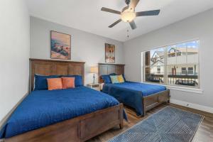 a bedroom with two beds and a ceiling fan at Green Wood Getaway - for 18 in Hollister
