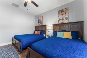a bedroom with two beds and a ceiling fan at Green Wood Getaway - for 18 in Hollister +45 photos
