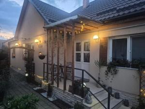 a house with a porch with lights on it at Casa LADIS in Iernut