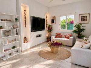 a living room with a couch and a table at Villa Docéa in Sainte-Anne