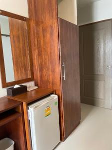 a kitchen with a white refrigerator and a wooden door at ON'S Place in Pattaya
