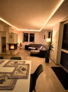 a living room with a couch and a fireplace at Bikehouse in Veľká Lomnica +56 photos