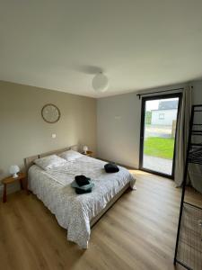 a bedroom with a bed and a large window at Mur des Horizons in Plouigneau +1 photo