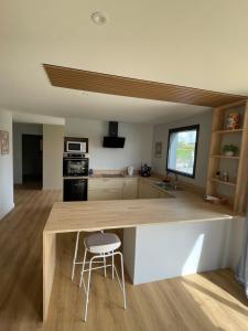 a kitchen with a wooden counter top in a room at Mur des Horizons in Plouigneau