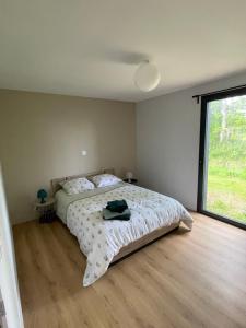 a bedroom with a bed and a large window at Mur des Horizons in Plouigneau