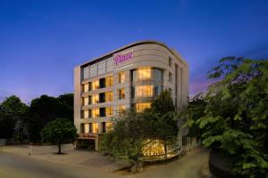 a hotel building with a sign on the side of it at Regenta Place CG Road in Ahmedabad