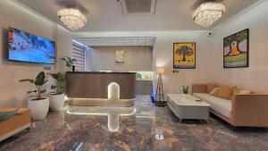 a living room with a couch and a table at Hotel Meridian in Jagādhri +22 photos