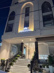 a building with stairs in front of a building at Hotel Meridian in Jagādhri