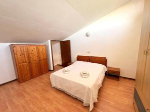 a bedroom with a bed and a wooden cabinet at Agriturismo Nani in Altavilla Monferrato