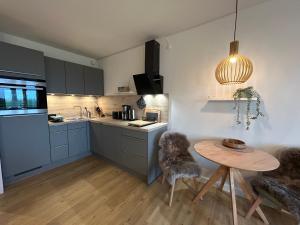 a kitchen with a table and a small table and chairs at Apartment Nordly in Wendtorf