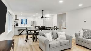 a kitchen and living room with a table and chairs at Motel Luzerne in Lake Luzerne
