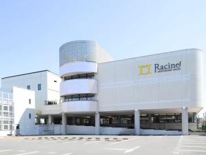 a large white building with a u radeland sign on it at Racine Shinmaebashi in Maebashi