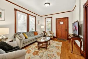 a living room with a couch and a table at Whimsy On B- 1 block to downtown Ashland in Ashland