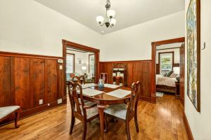 a dining room with a table and chairs and a bedroom at Whimsy On B- 1 block to downtown Ashland in Ashland