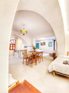 a dining room with a table and a bedroom at El Beaterio Apartments in Tarifa +218 photos
