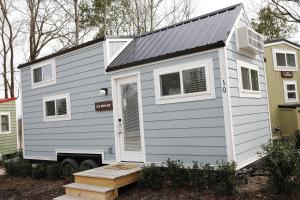 a gray tiny house with a grey roof at River and Twine in Rocky Mount
