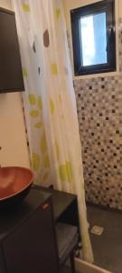 a bathroom with a window and a table and a chair at Posada IRSIS in La Pedrera