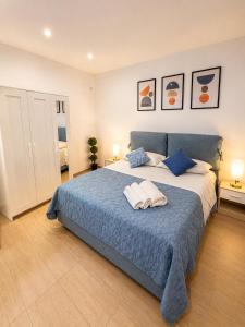 a bedroom with a large bed with two towels on it at Casetta Villabate in Villabate
