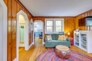 a living room with a couch and a table at Blocks to Beach & Eats! Elk Rapids 'Cozy Cottage' in Elk Rapids