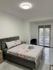 a bedroom with a bed in a room with a window at Laki in Donji Štoj