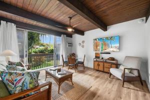 a living room with a couch and a table at Kona Mansions#226 in Kailua-Kona