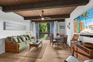 a living room with a couch and a table at Kona Mansions#226 in Kailua-Kona