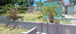 a garden with pink flowers and a fence at Paradise treasure view in Montego Bay