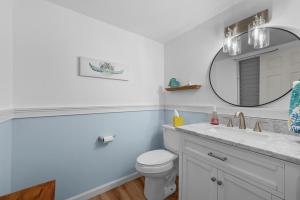 a bathroom with a white toilet and a mirror at Kona Mansions#226 in Kailua-Kona +31 photos