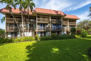 a large building with a lawn in front of it at Kona Mansions#226 in Kailua-Kona