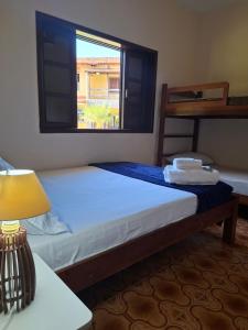 a bedroom with a large bed with a window at Casa Bella Itaúna Suites in Saquarema +47 photos