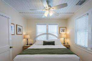 a bedroom with a bed with a ceiling fan at KW41 Amelia House in Key West