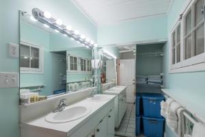 a bathroom with two sinks and two mirrors at KW41 Amelia House in Key West +17 photos